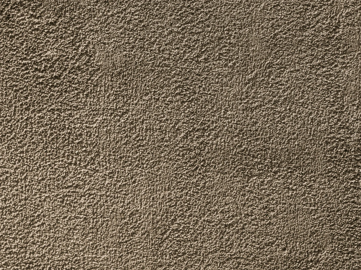 exterior-painting-closeup-rough-textured-cheshire-painters Rendered cream detached house exterior masonry painting in Wilmslow