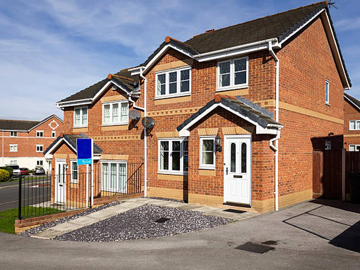 Exterior painting of a red brick semi-detached house by Cheshire Painters