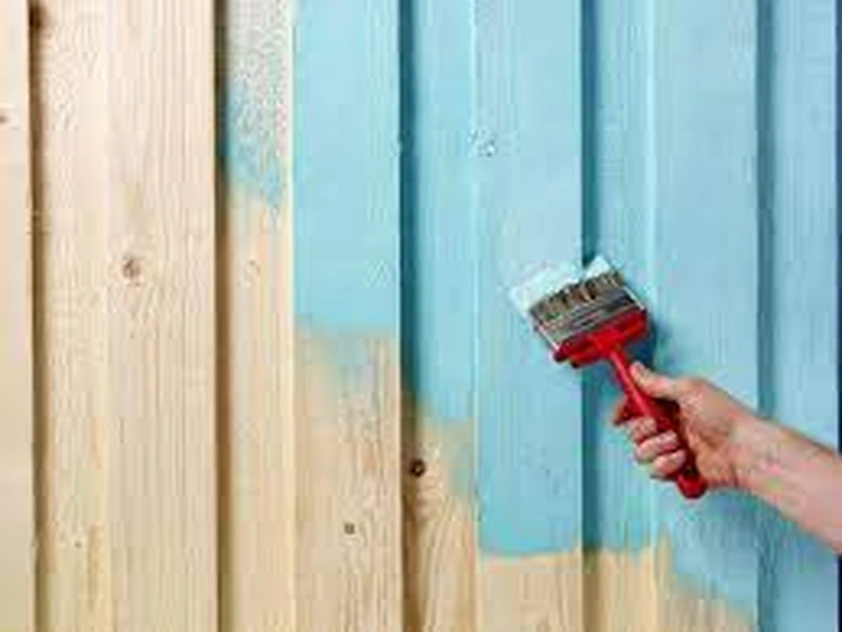 Fence being painted with brush by Cheshire Painters