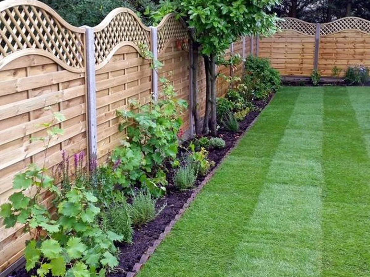 Decorative wooden garden fence painted by Cheshire Painters in Cheshire