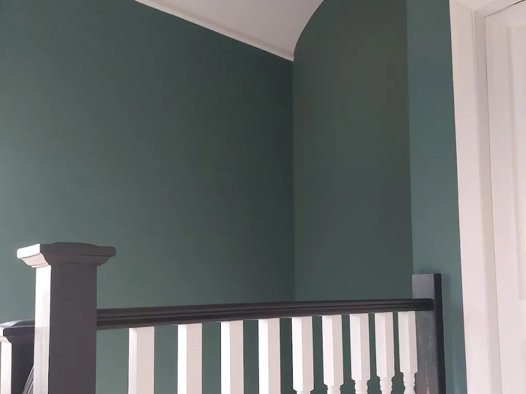 Hallway Painting 2 Upstairs landing with teal walls and a contrasting balustrade, painted by Cheshire Painters.