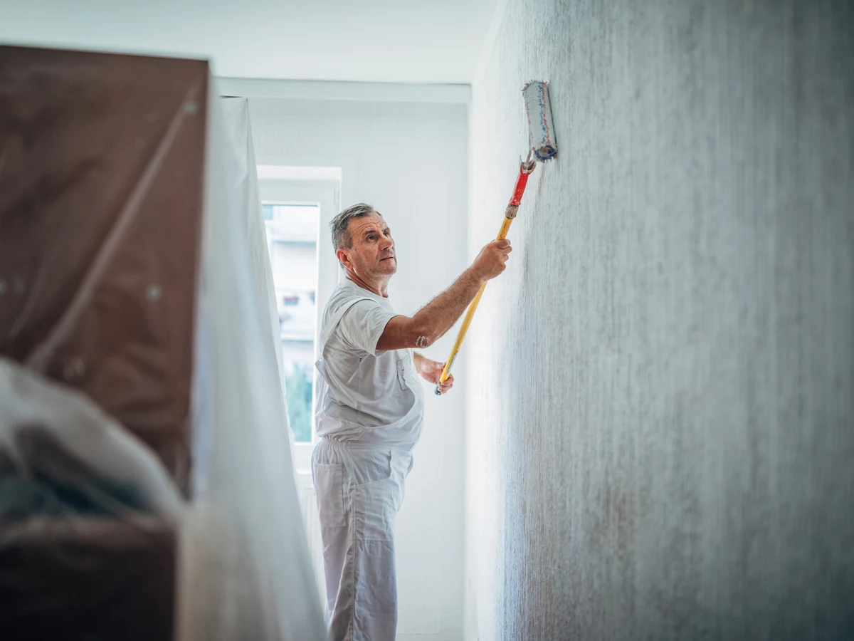 Painter using a roller by Cheshire Painters